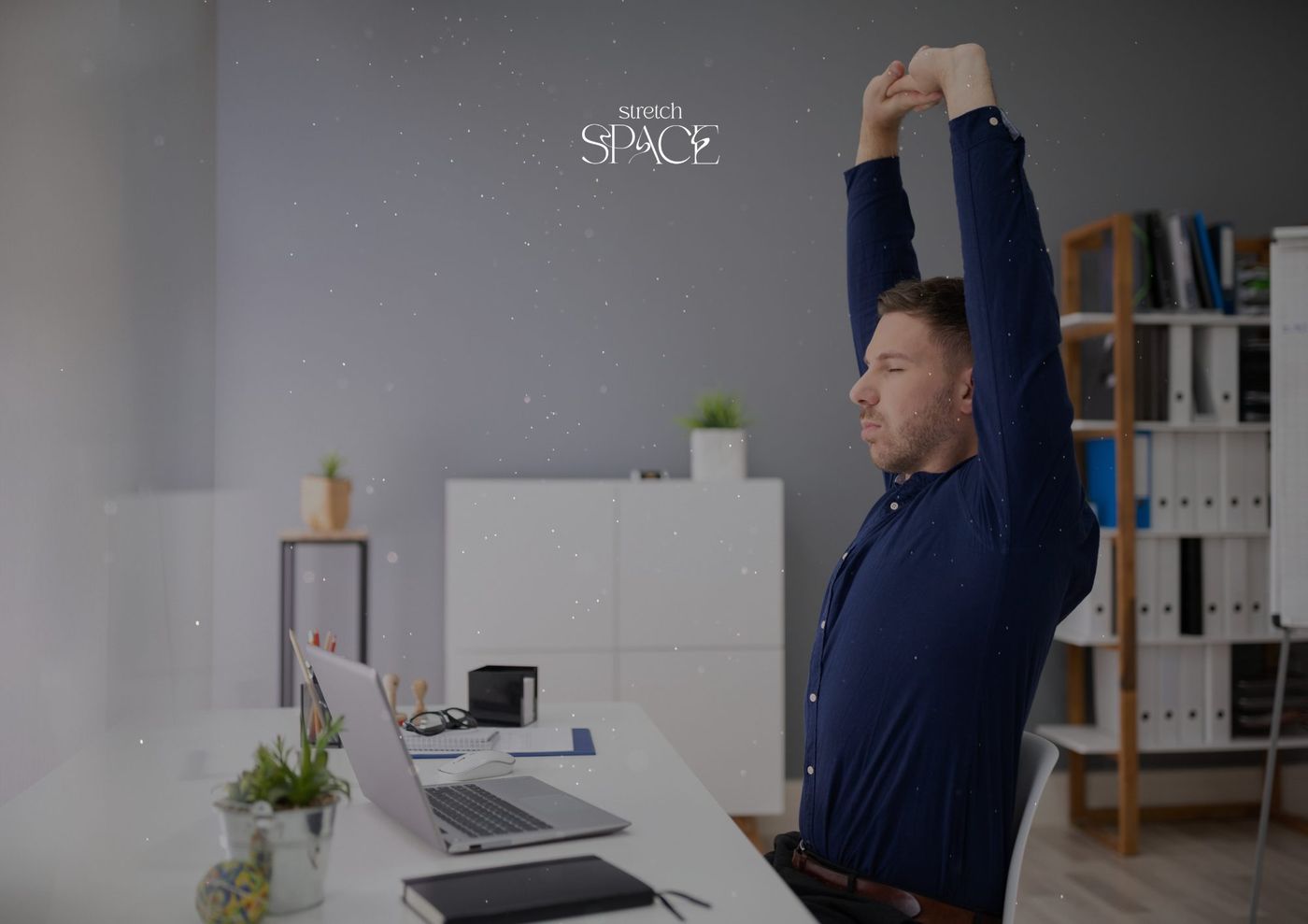 Client standing and reaching overhead during a mobility warm-up at the Stretch Space studio
