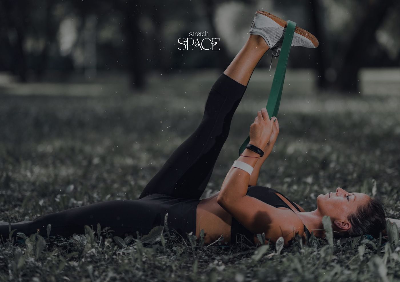 Assisted hamstring stretch with the client relaxed on their back and the leg supported at the ankle