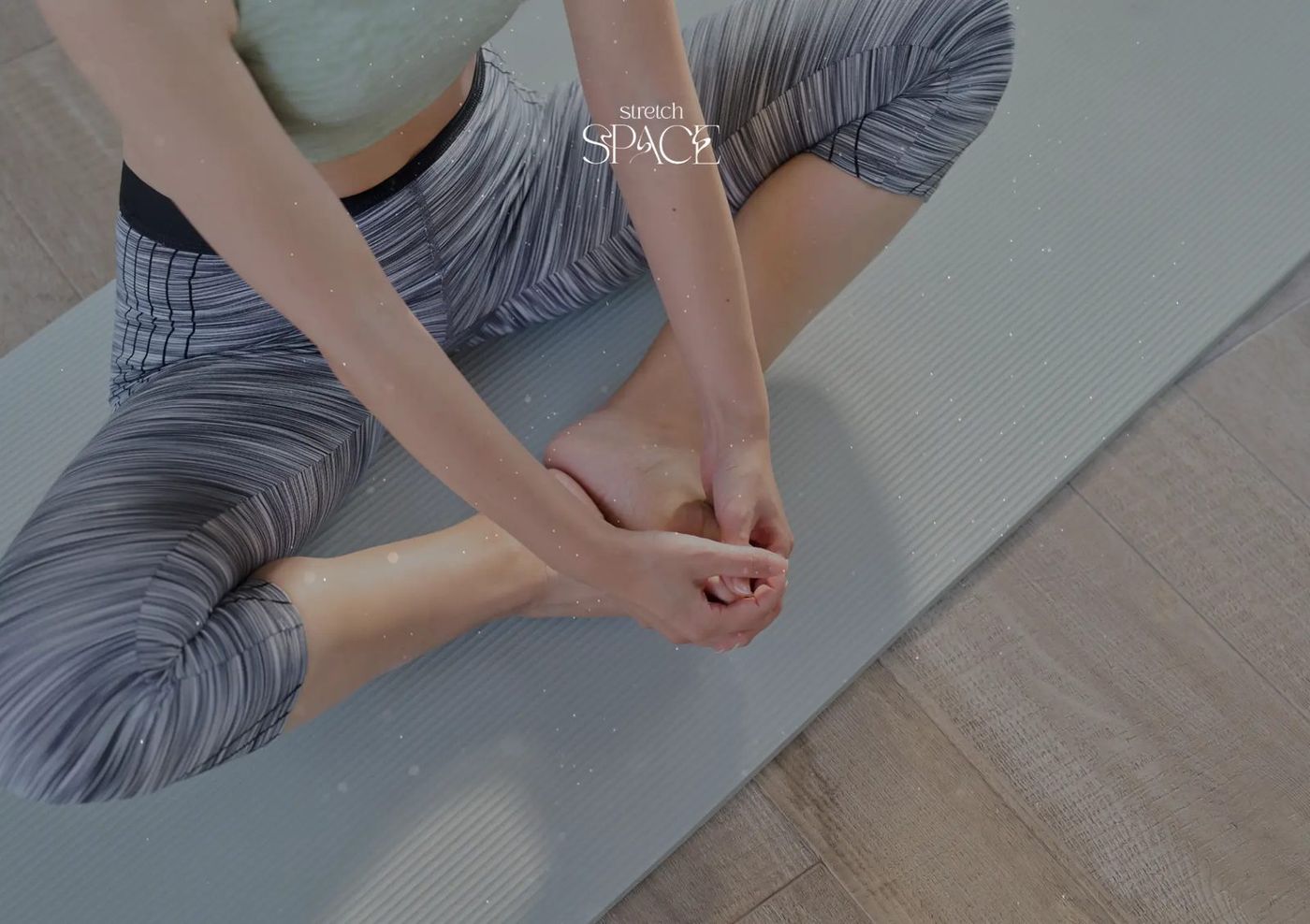 Client lying on a stretch table while a specialist guides the hip through a controlled range of motion