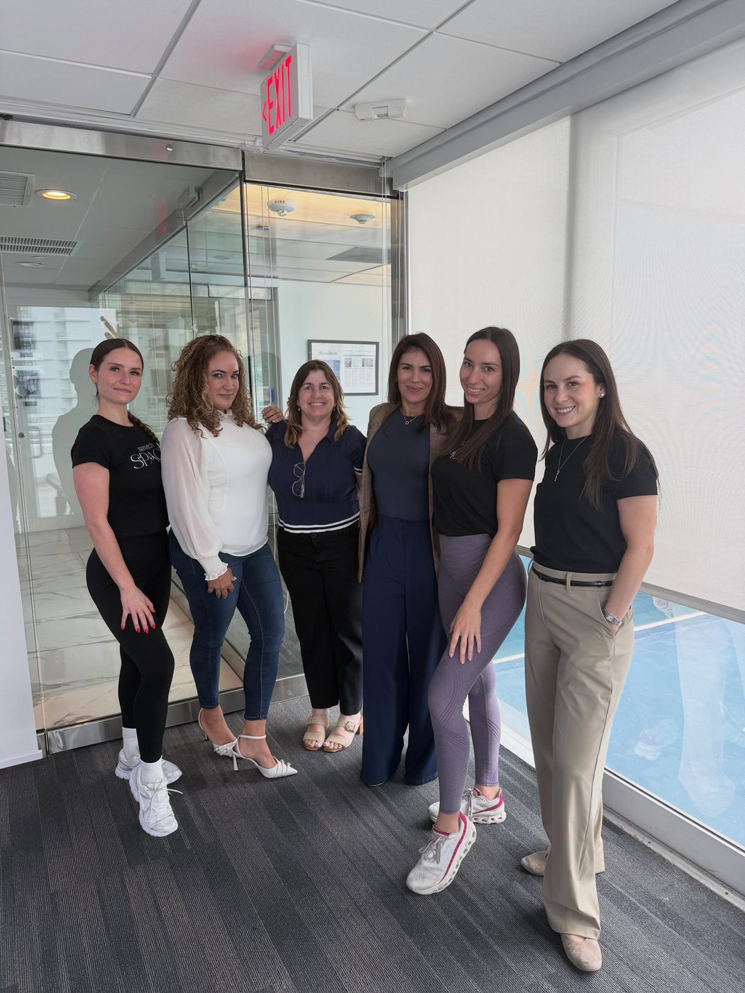 The Stretch Space team during an on-site corporate stretching session in Coral Gables