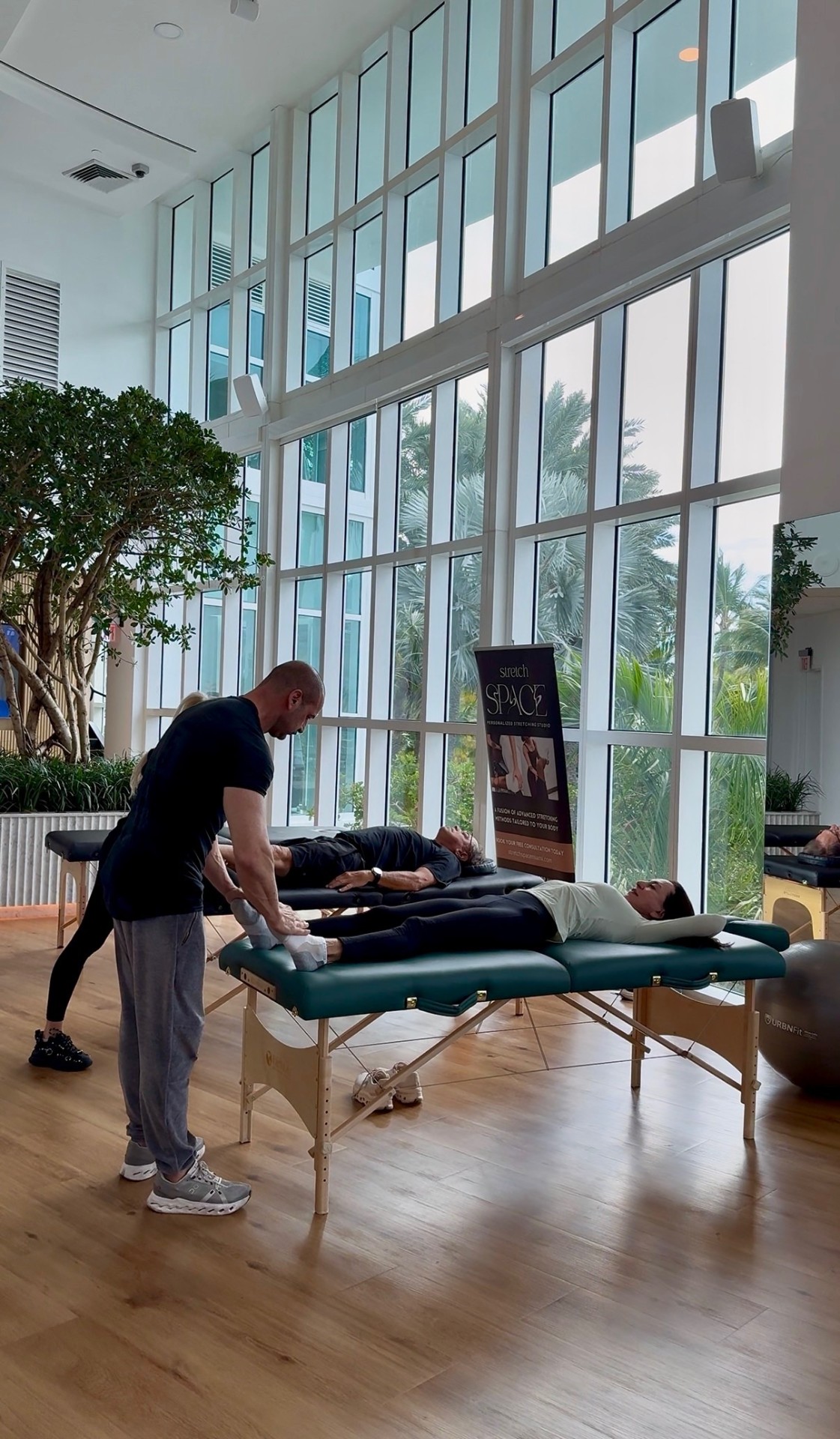 Stretch Space specialists providing on-site assisted stretching at a Miami wellness event